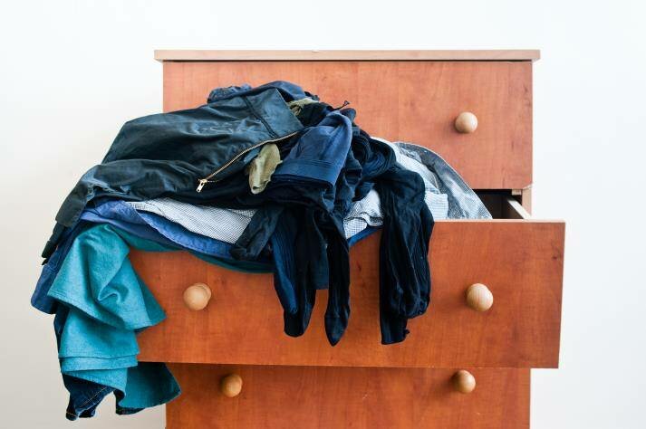 Clothes spilling out of drawers