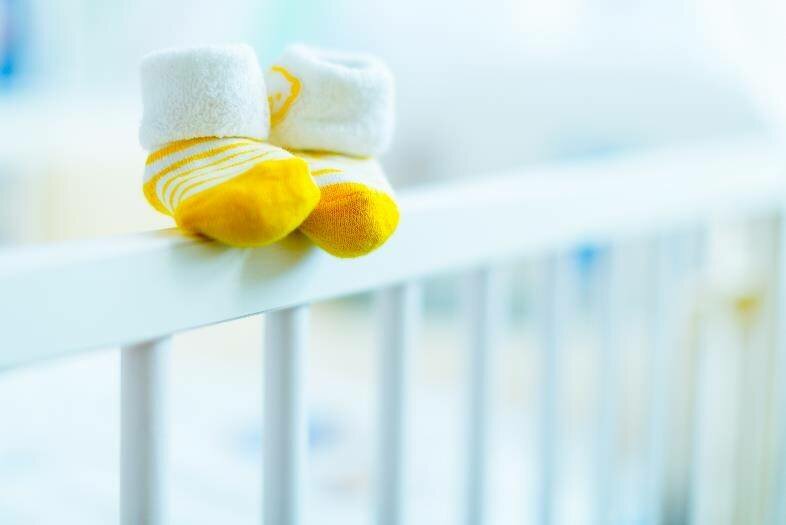 baby socks on top of crib