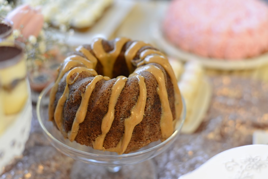 Close up of a bundt cake drizzled with frosting.