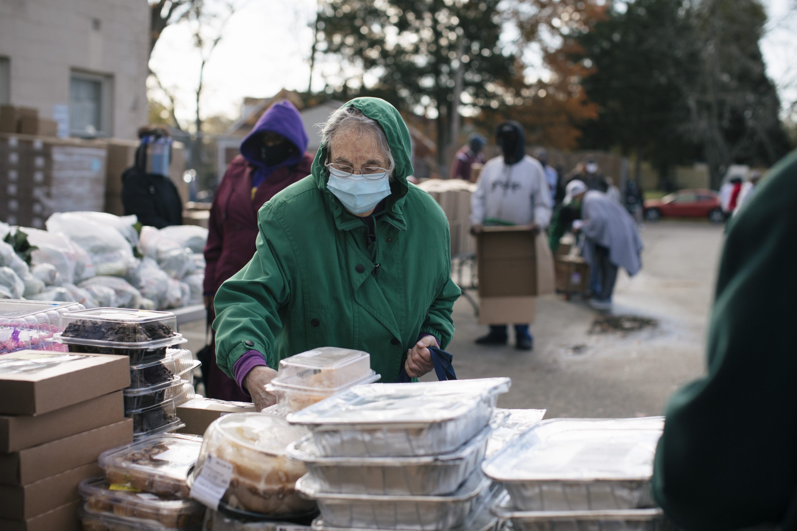 Senior citizen at a food donation area with mask on