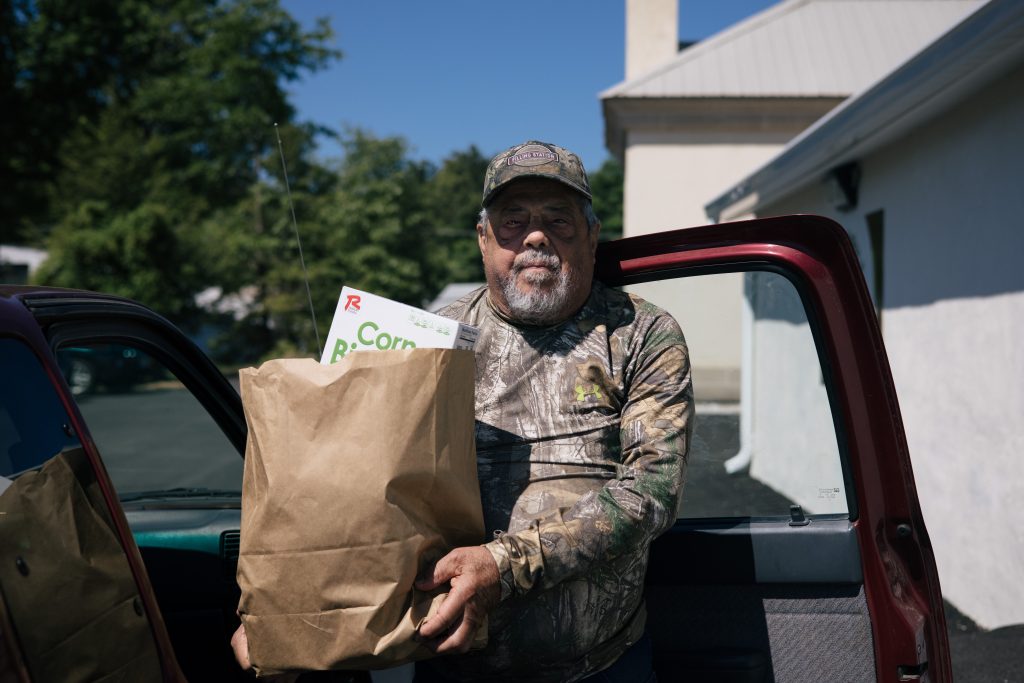 Man holding bag of food donations